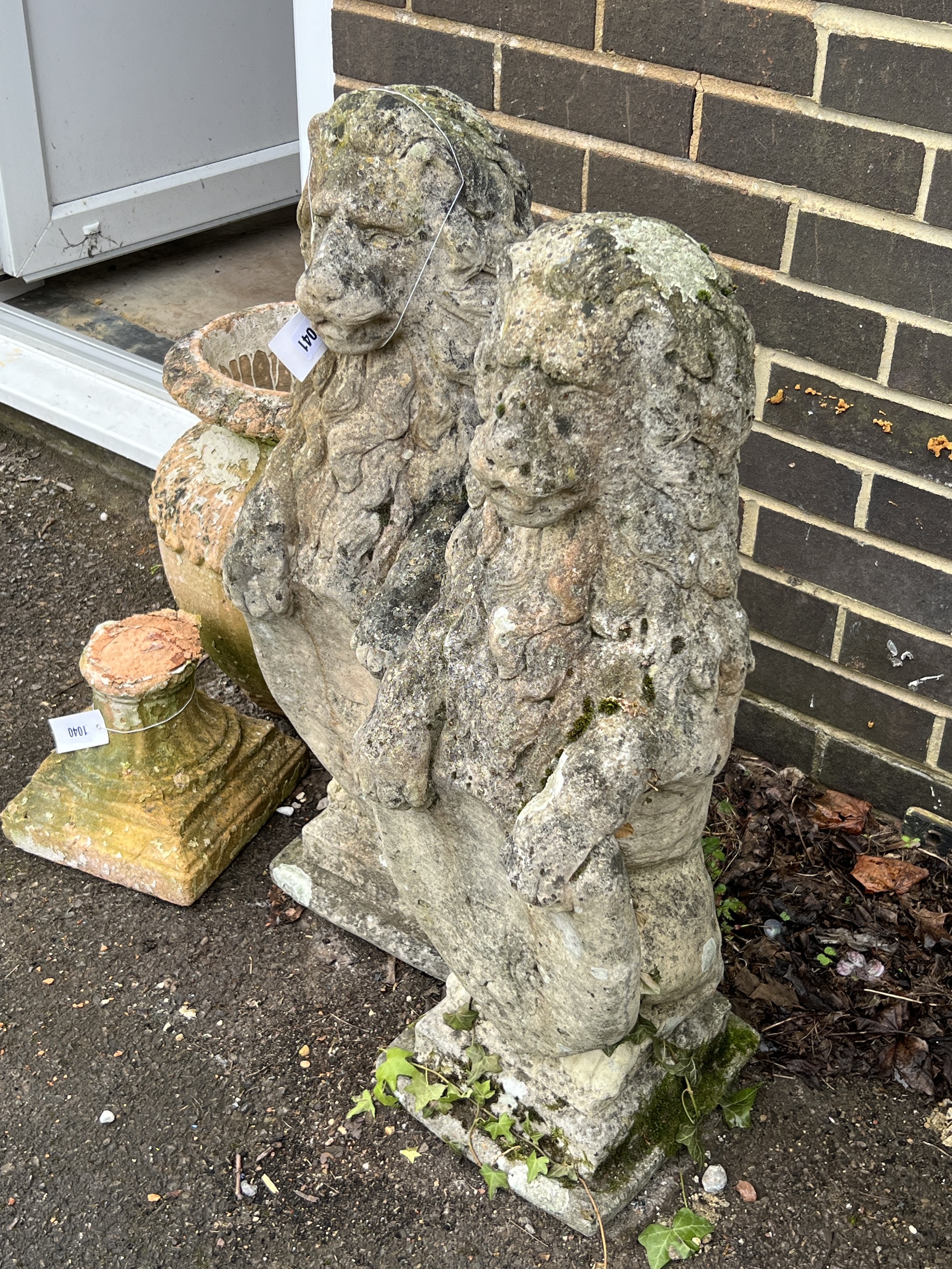 A pair of reconstituted stone heraldic lion garden ornaments, height 78cm
